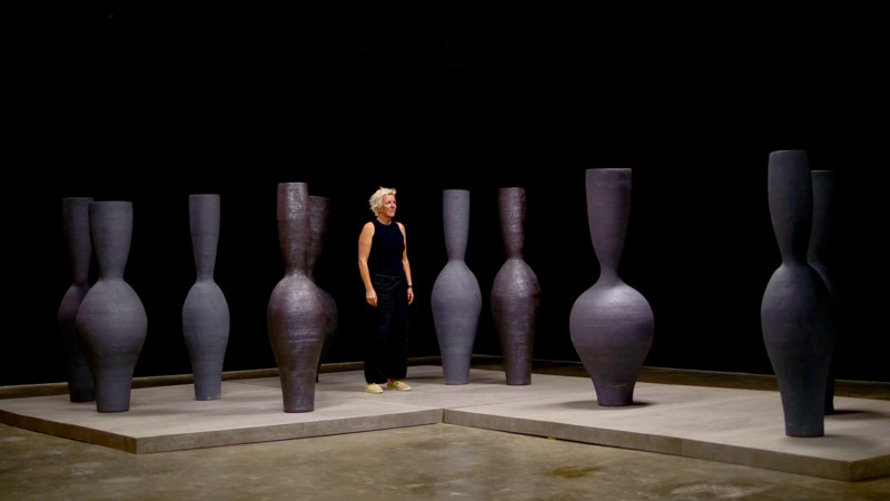Stefanie in TH Din Clay ton next to vases